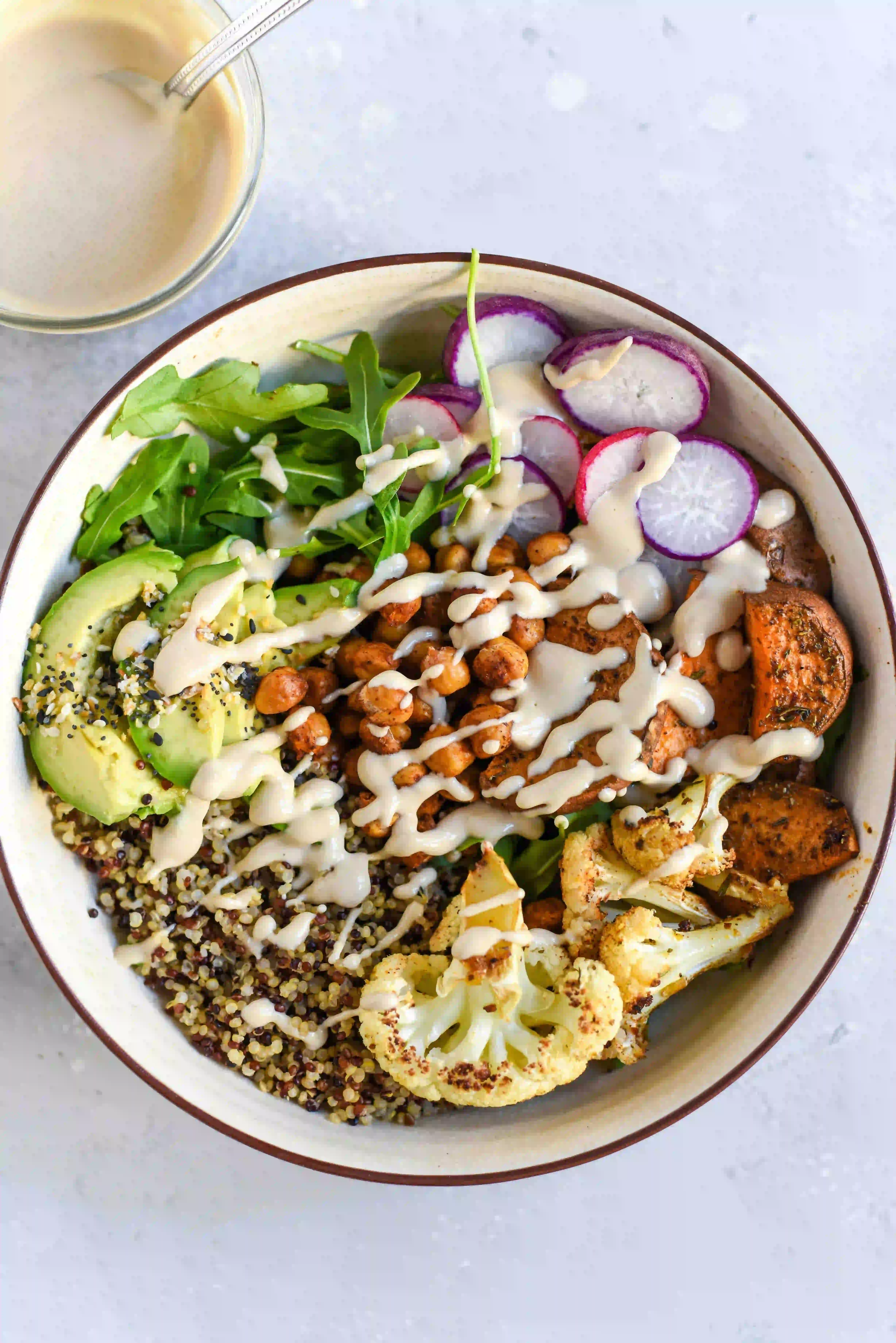  A chickpea salad with lots sauzzy ranche sauce dressing on it