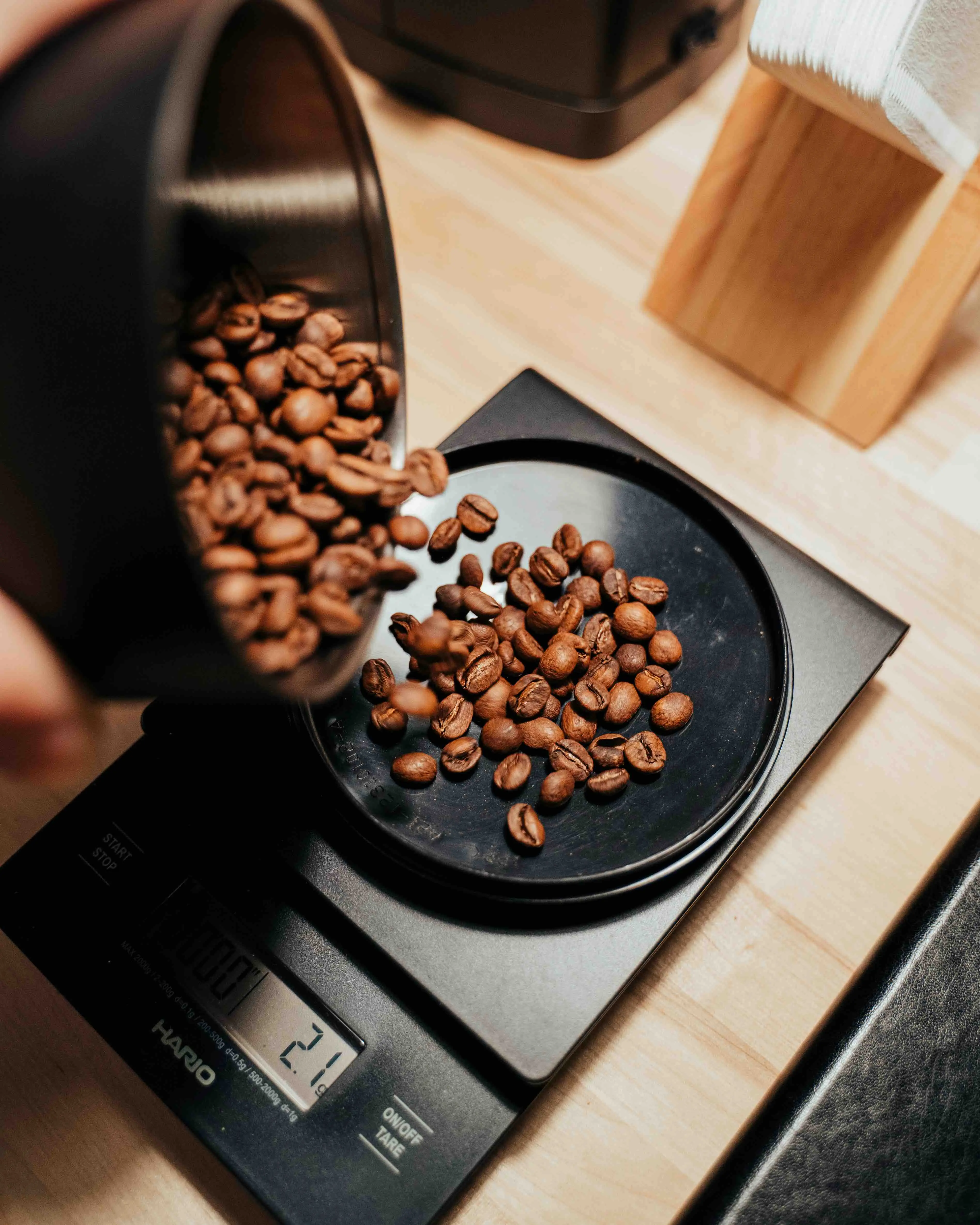 An image of counting macros on a food scale and pouring beans onto it to count the cals/macros
