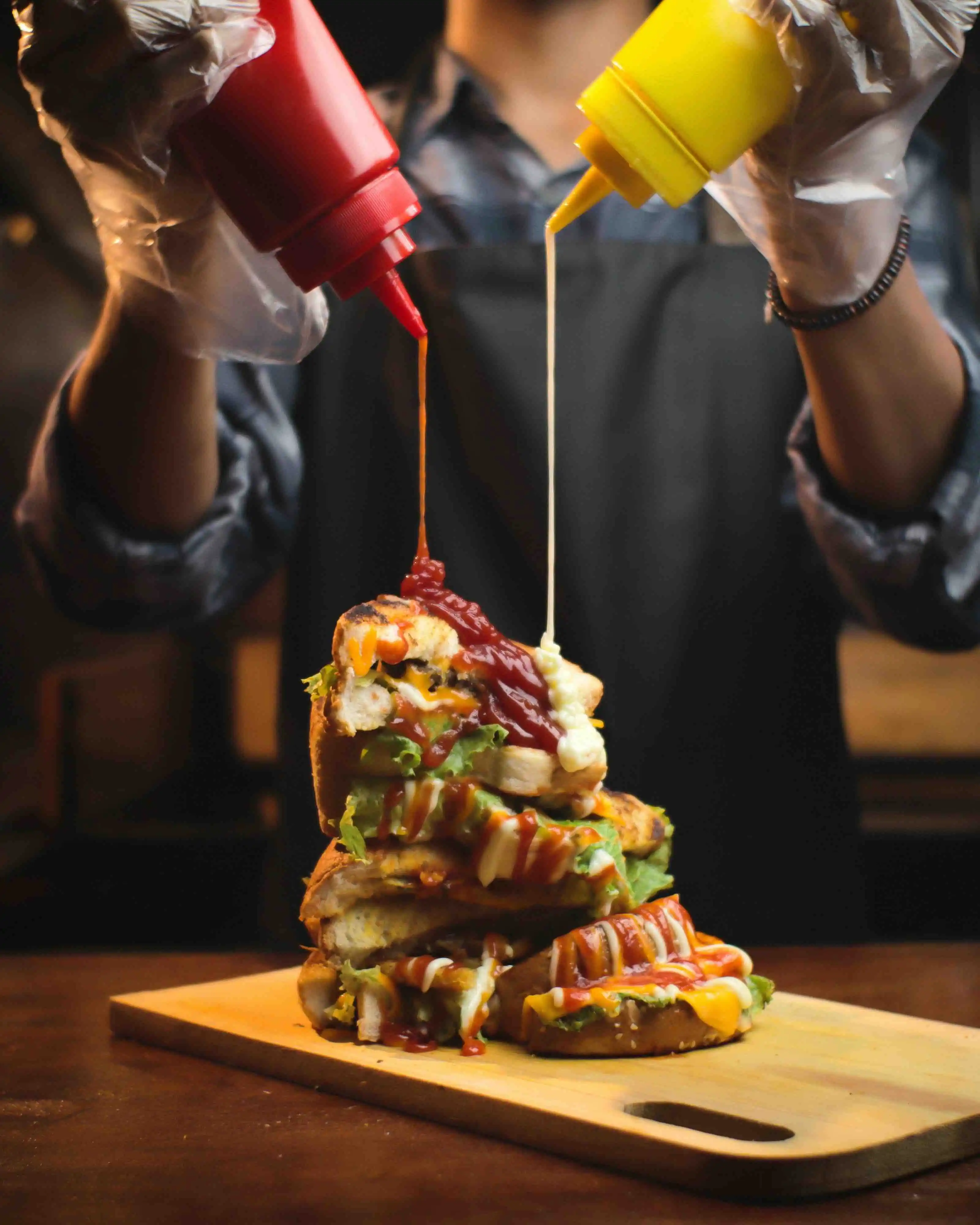 burger being drowned in sauzzy sauce