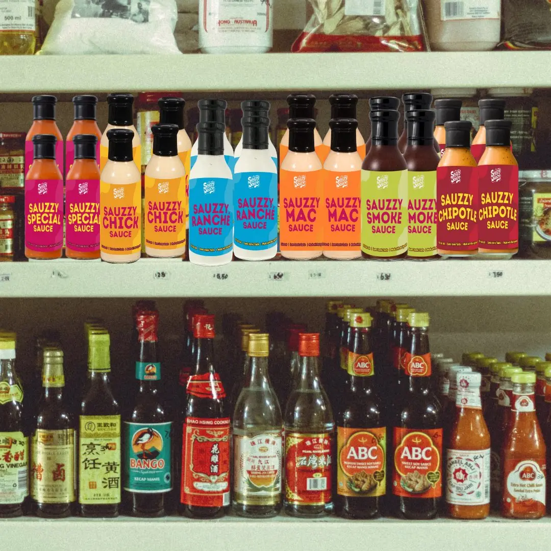 Sauce Lineup image showing all 6 of Sauzzy Sauces original sauces - Sauzzy Chick Sauce, Sauzzy Smoke Sauce, Sauzzy Special Sauce, Sauzzy Smoke Sauce, Sauzzy Ranche being displayed on a store shelf